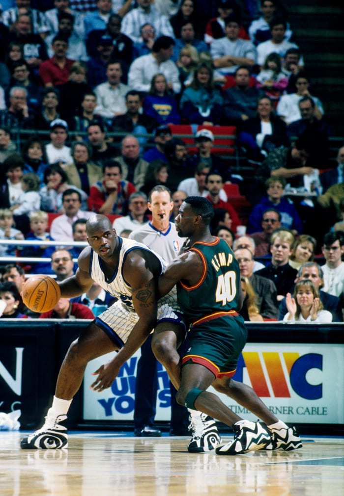 Orlando Magic center Shaquille O'Neal dribbles against Seattle Supersonics center Shawn Kemp.